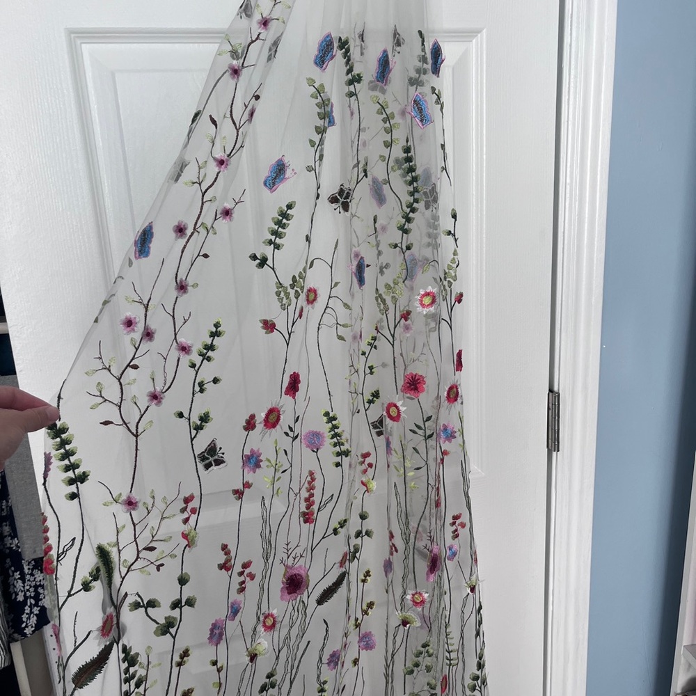 Embroidered bridal veil with floral and butterfly detail.